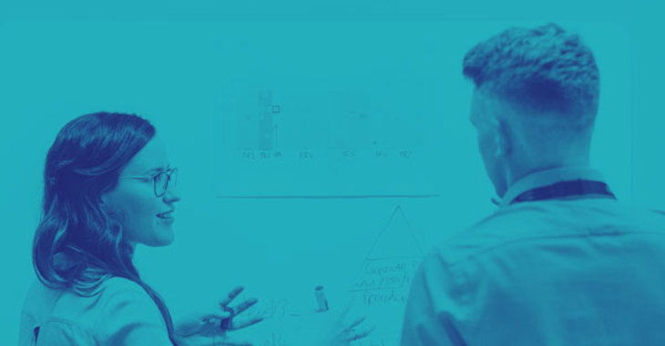 Female Electronics Engineer Discusses Data In Meeting With Colleague Blue Duo