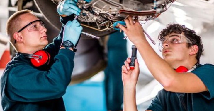 Two Men Work On An Aircraft 