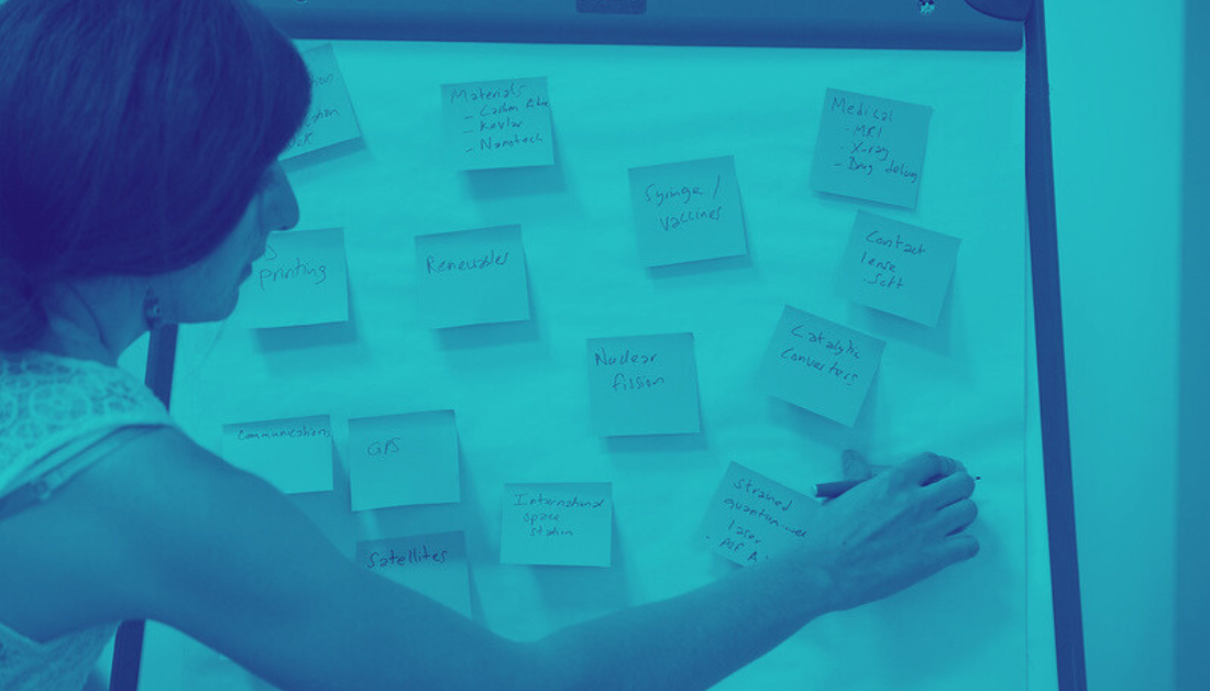 Women using post-it notes in duotone