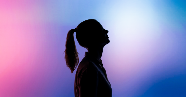 silhouette of woman in front of pink and blue background
